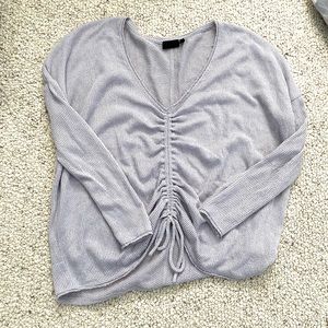 Out from under oversized scrunched sweater